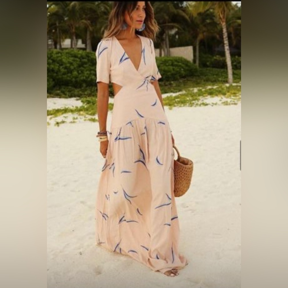 Light pink and navy blue maxi dress with drop waist and hip cut outs.